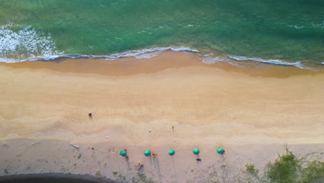 Umbrellas-and-Deck-Chairs-on-the-Beach,-Spend-your-Holidays-at-this-Remote-Tropical-Beach-Resort,-Luxury-Holidays-with-Beautiful-Beach-from-Above