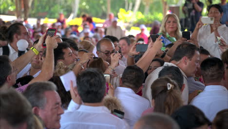 Mexican-female-presidential-candidate-Xochitl-Galvez-walking-through-the-crowd-taking-pictures-with-her-supporters-at-a-rally-trying-to-get-to-the-stand