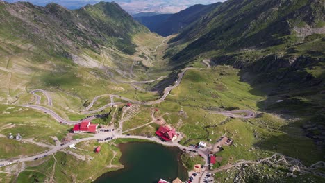 Aerial-shot-of-the-Transfagarasan-road-winding-through-the-Fagaras-Mountains,-Romania,-on-a-sunny-day