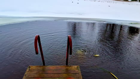 Natural-bubbles-rising-from-bottom-of-pond-water-in-winter-season