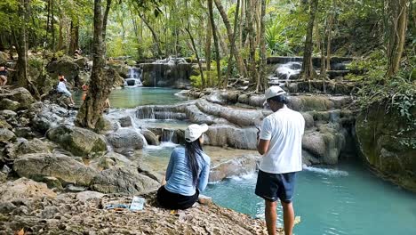 Visitors-explore-Erawan-National-Park's-cascading-waterfalls-and-serene-pools,-Kanchanaburi,-timelapse