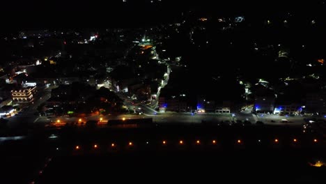 Aerial-night-view-of-a-bustling-cityscape-with-vivid-street-lights-and-traffic