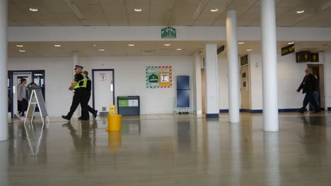 British-police-and-security-walking-through-an-airport-lounge-in-England