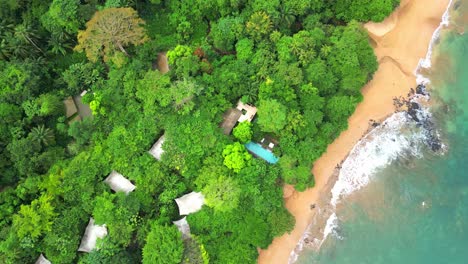 Circular-view-of-houses-in-a-resort-at-Sundy-beach,covered-by-forest-at-Prince-Island,Sao-Tome,Africa