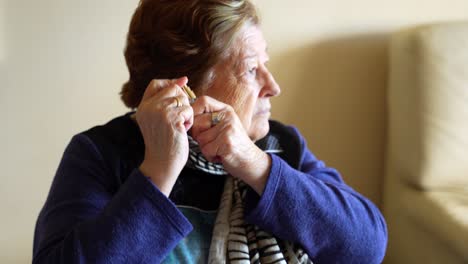 Elderly-woman-spraying-cologne-before-going-out