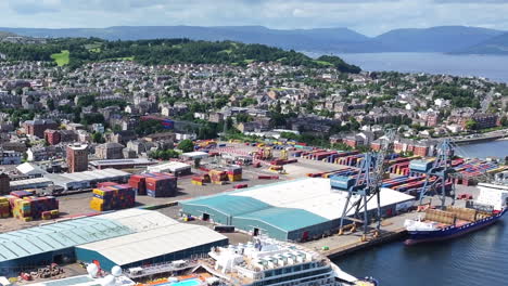 Aerial-View,-Port-of-Greenock,-Scotland-UK-on-Sunny-Day,-Cityscape,-Cargo-Terminal,-Cranes-and-Shipping-Containers,-Drone-Shot