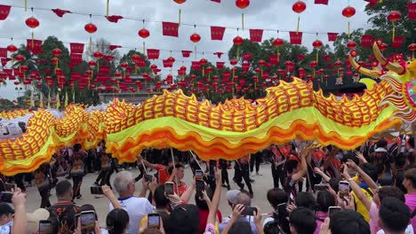 Devotees-and-tourists-happily-watch-the-Dargon-Dance-performances-and-take-photos-and-videos-of-the-annual-tradition-of-Chingay-in-Johor-Bahru-Old-Chinese-Temple-'Xing-Gong'-Malaysia