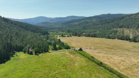 Wide-drone-shot-of-the-manmade-bridge-crossing-Breakfast-Creek-in-Spirit-Lake,-Idaho