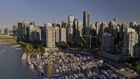 Vancouver-BC-Canada-Aerial-v51-flyover-Coal-Harbour-in-downtown-capturing-cityscape-of-upscale-condos,-marina,-waterfront-park-and-Metrotown-in-the-backdrop---Shot-with-Mavic-3-Pro-Cine---July-2023