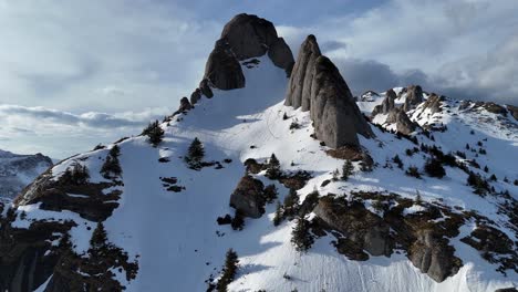 Ciucas-mountains-with-snow-patches-under-a-clear-blue-sky,-early-spring,-aerial-view