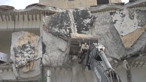 Heavy-machinery-crane-exavator-demolishes-building-for-urban-renewal-after-being-destroyed-by-IDF-bomb