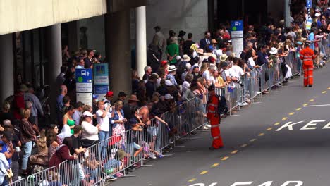 Large-crowds-of-people-in-Brisbane-lined-up-along-Adelaide-Street,-patiently-waiting-for-the-commencement-of-traditional-Anzac-Day-parade