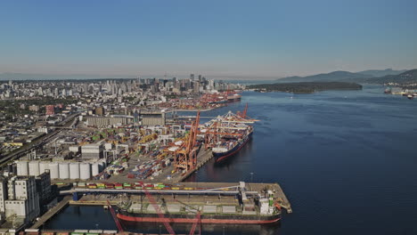 Vancouver-BC-Canada-Aerial-v94-drone-flyover-the-harbour-capturing-Eastside-shipyards,-Centerm-and-Vanterm-container-terminals-with-downtown-cityscape-views---Shot-with-Mavic-3-Pro-Cine---July-2023
