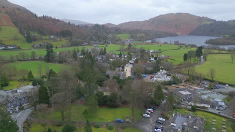Drone-approaching-Grasmere,-a-mountain-village-located-by-the-lake-at-Cumbria,-in-Westmorland-and-Furness,-in-Northwestern-England-in-United-Kingdom