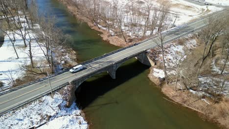 Aerial-drone-video-with-creek-and-transportation-bridge-going-over-it