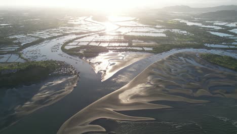 an-aerial-view-of-a-beautiful-scenery-where-the-riverbanks-connect-to-the-sea-and-sandbars-can-be-seen-on-a-beautiful-day