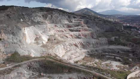 Aerial-view-over-old-abandoned-empty-quarry-industry-sunny-day