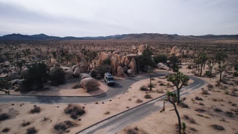 A-Mercedes-Sprinter-VAN-parking-in-Joshua-Tree-National-Park-while-a-drone-orbiting-around-it