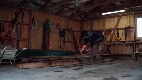 Man-Sorting-Plank-Of-Woods---Wide-Shot