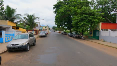 POV-view-backward-while-driving-in-the-strees-of-São-Tomé-city,-Africa