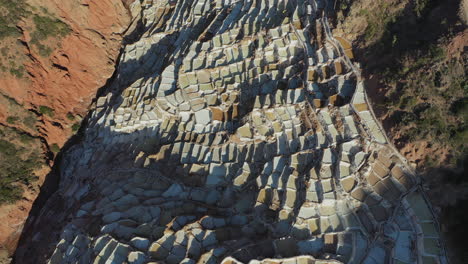 Flight-Over-Salinas-de-Maras-Peru-Sacred-Valley-Cuzco-Salt-Mine-Stucked-between-Mountains,-End-of-the-Day