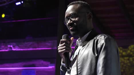 Black-Male-speaker-with-microphone-at-event