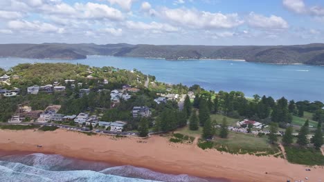 Aerial-reveal-of-Pittwater-Palm-Beach-Golf-Club-and-North-Palm-Beach-sand-and-surf