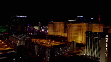 Las-Vegas-at-Night,-Aerial-View-of-Hotels-Casinos-and-Condominiums-by-Strip,-Drone-Shot