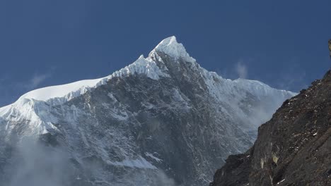 Close-up-of-the-icy-rocky-summit-of-Langtang-Lirung-against-a-blue-sky