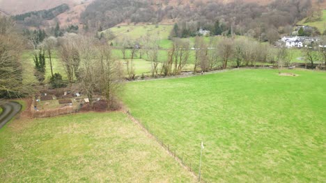 Pedestal-drone-shot-showing-a-part-of-Grasmere,-a-mountain-village-by-the-lake,-located-in-Cumbria-at-Westmorland-and-Furness-in-Northwest-England,-Great-Britain