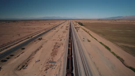 A-drone-flying-over-an-abandoned-train-wagon-in-the-desert