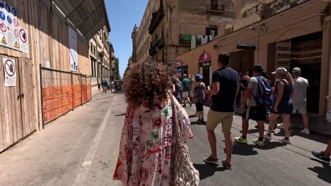 Follow-shot-of-the-walking-tourists-in-the-Via-Vittorio-Emanuele-Street-in-Palermo-Italy