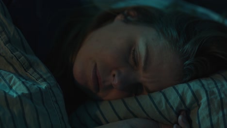 Close-up-of-light-suddenly-shining-on-sleeping-woman