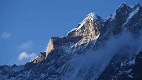 Close-up-of-the-icy-rocky-summit-of-Langtang-Lirung-against-a-blue-sky