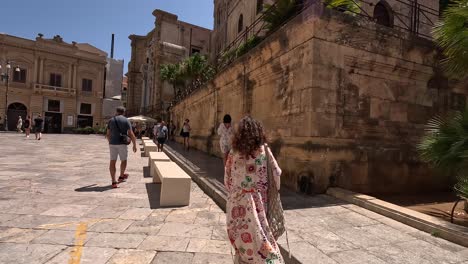 Follow-shot-of-the-walking-tourist-women-in-Palermo-city-center-in-Italy