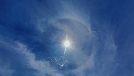 Fast-moving-clouds-formation,-sun-in-the-center-time-lapse-blue-sky