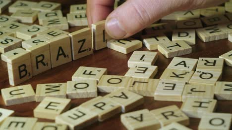 Close-up:-Word-BRAZIL-is-formed-from-Scrabble-tile-letters,-table-top