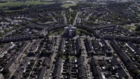 Backwards-aerial-movement-revealing-greenery-around-residential-neighborhood-in-suburbs-of-Zutphen