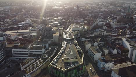 K-In-Lautern-Shopping-Mall-in-Kaiserslautern-City-at-Golden-Hour,-Drone-Dolly