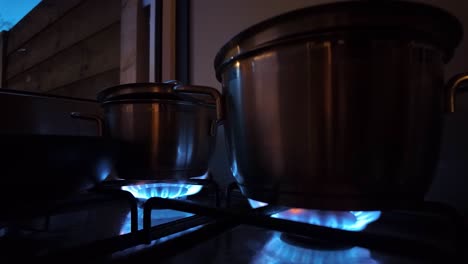 Stainless-Steel-Pots-Over-Fire-On-Cooking-Stove-In-The-Kitchen