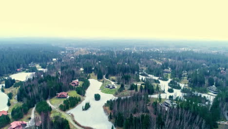 Iconic-lake-islands-and-resort-buildings,-aerial-drone-view,-forestry-landscape