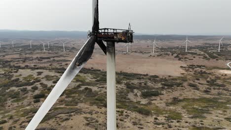 Medium-closeup-view-of-a-wind-turbine-burnt-and-destroyed-by-a-fire