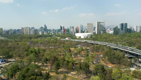 Aerial-view-Chapultepec,-Mexican-flag,-Auditorio-Nacional,-avenues,-cars-and-Mexico-City