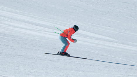 Skier-skiing-down-the-slope-on-a-run-at-Alpensia-Ski-Resort---telephoto-tracking-slow-motion-shot