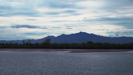 Boat-ride-follow-helicopter-flight-Nausori-Highlands-Tourism-Fiji-Nada-Suva-Garden-Island-Coral-Coast-Taveuni-morning-mountain-peaks-tropical-island-palm-coconut-tree-cloudy-blue-sky-calm-bay