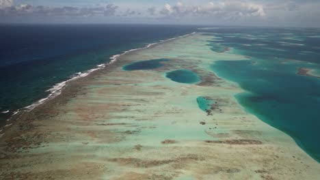 The-vibrant-coral-barrier-at-los-roques-with-turquoise-waters,-aerial-view