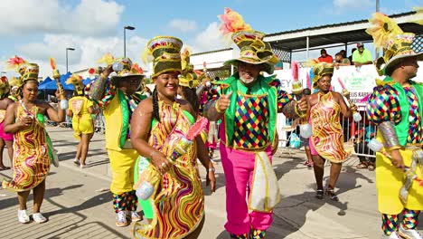 Golden-swirling-bodysuit-costumed-performers-dance-and-clap-in-parade