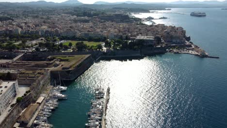 Drone-Shot-over-Mandraki-Marina-and-Corfu-City,-Kerkyra,-Greece
