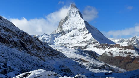 Lake-Riffelsee-Zermatt-Switzerland-Glacier-peak-Gornergrat-Railway-train-stop-October-clear-blue-sky-The-Matterhorn-peak-ski-resort-first-fresh-snowfall-landscape-scenery-autumn-Swiss-Alps-slider-left