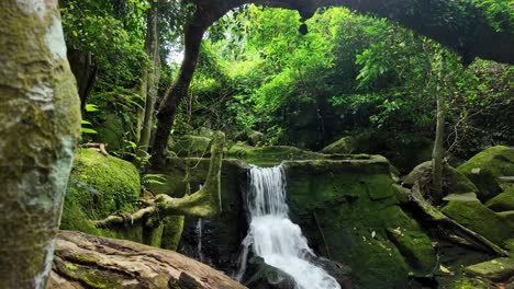 Small-waterfall-cascading-over-rocks-in-a-lush-forest-on-Koh-Samui,-Thailand,-serene-and-untouched